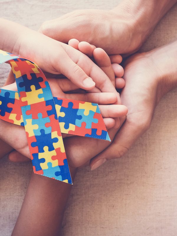holding-puzzle-ribbon-autism-awareness